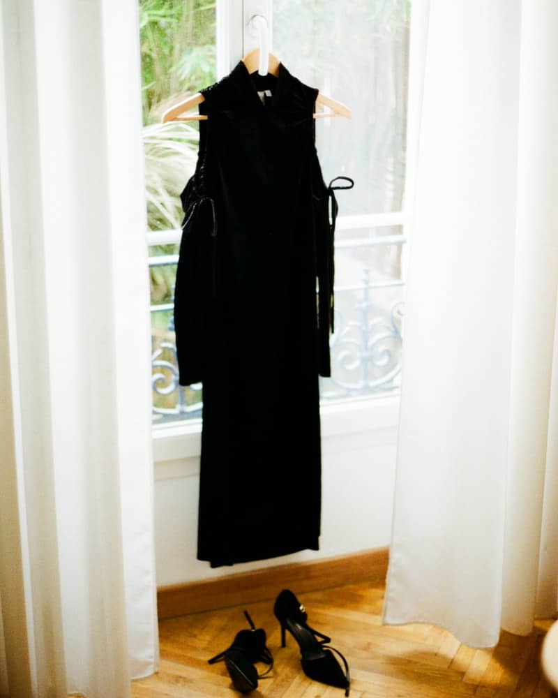 a black faux leather dressing hanging on a hanger