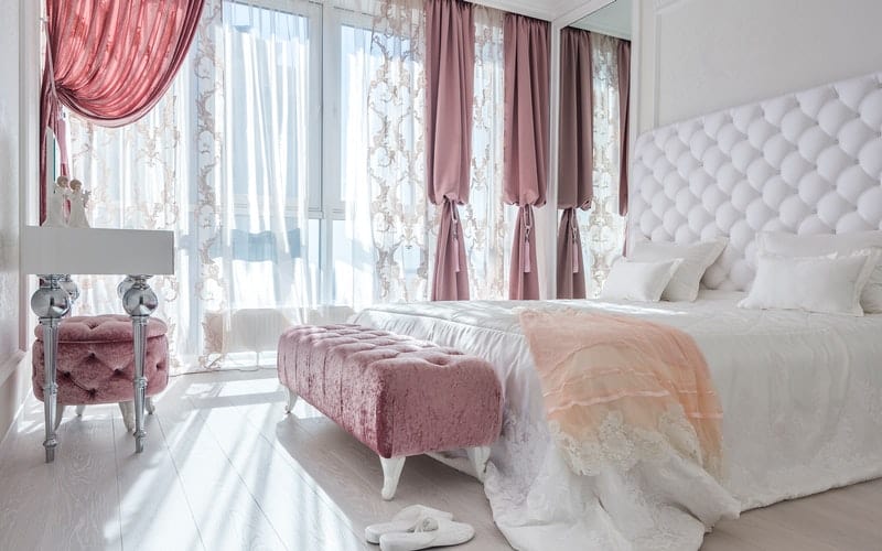 a pink and white room with velvet upholstery