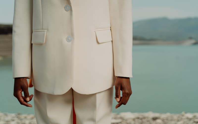 a close up view of a man wearing a white suit