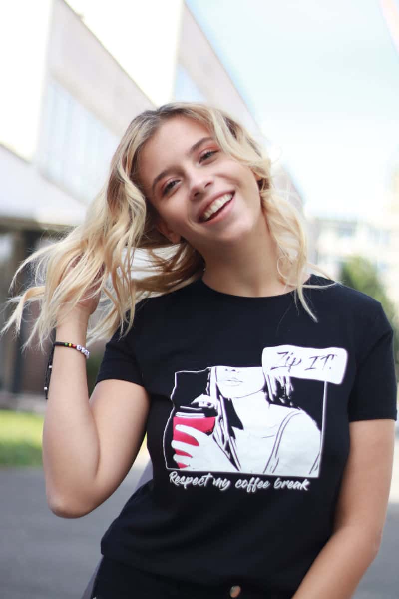 a woman wearing a screen printed t shirt who is smiling