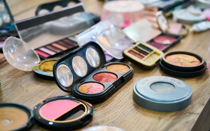 a variety of makeup open on a table