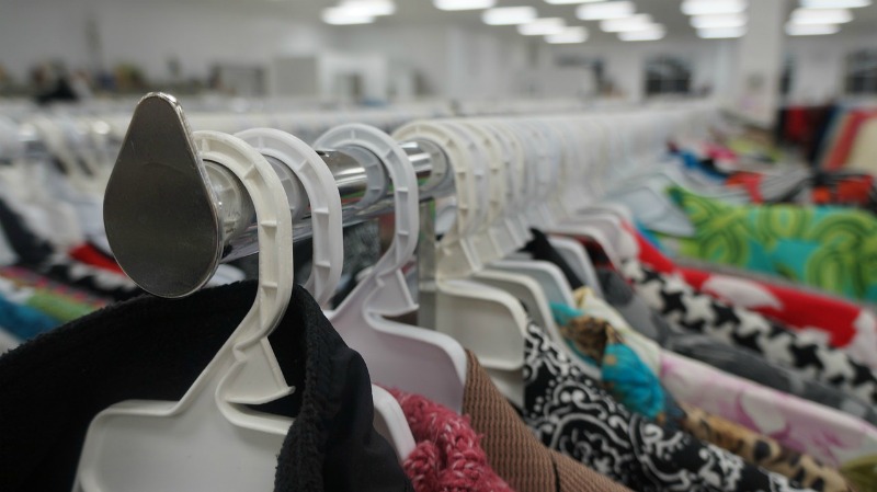 rows of clothes at a thrift store