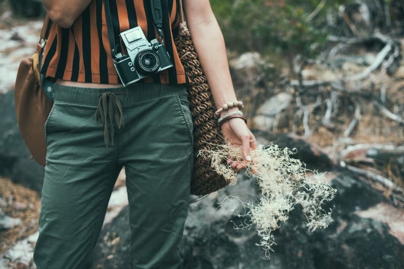 a women wearing hiking pants holding a camera