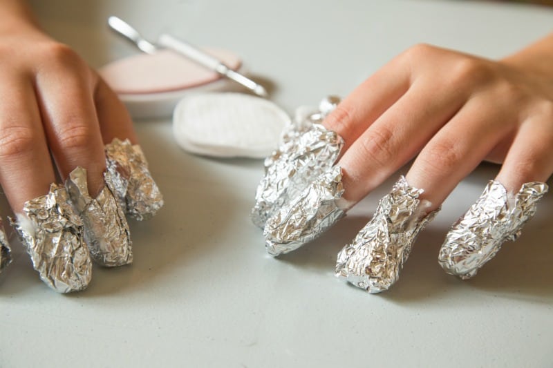 a woman with foil on her nails