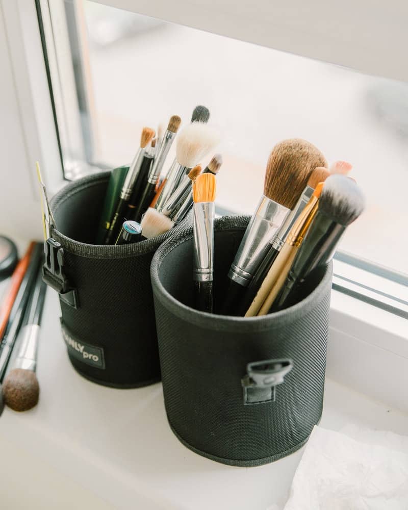 makeup brushes drying in a cup with the bristles up
