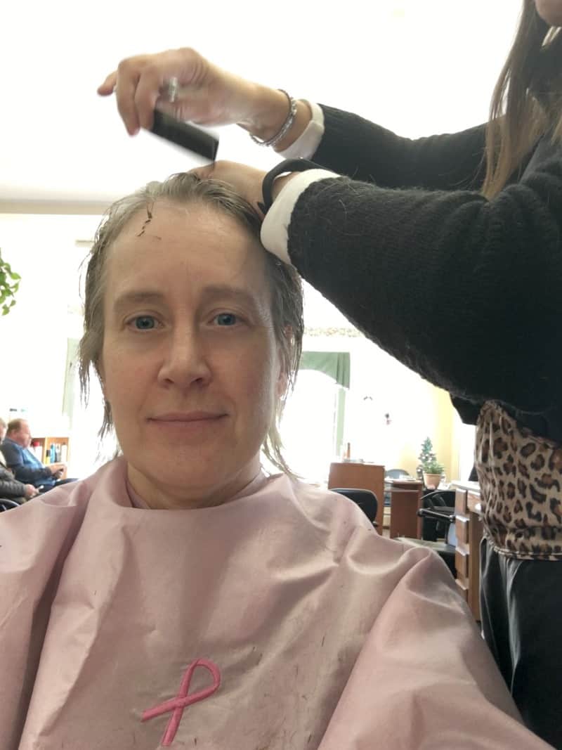 a woman having split ends cut at the salon