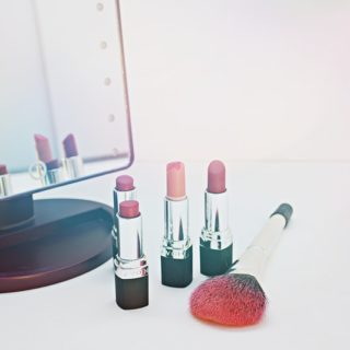 lipsticks in front of a makeup mirror