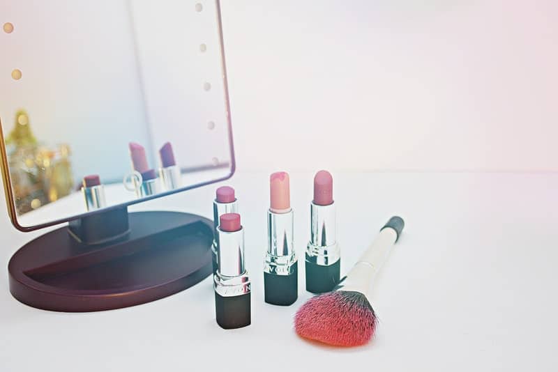 lipsticks in front of a makeup mirror