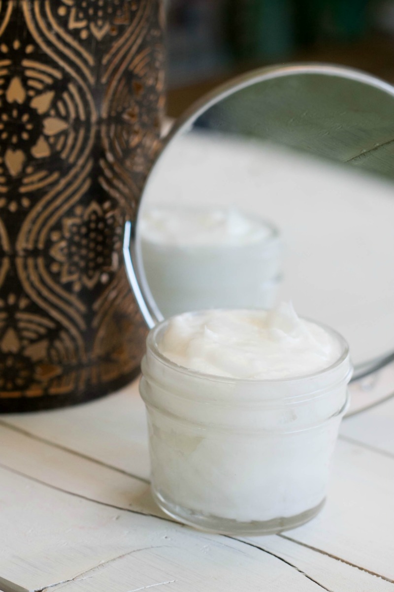 a container of coconut oil in front of a mirror