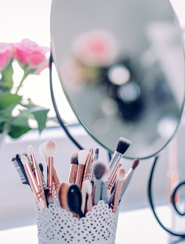 a basket of makeup brushes on a vanity