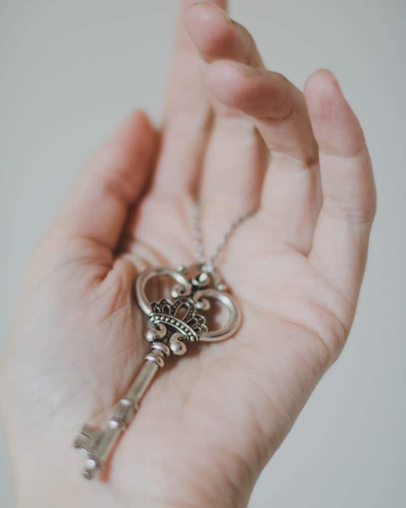 woman holding akeleton key