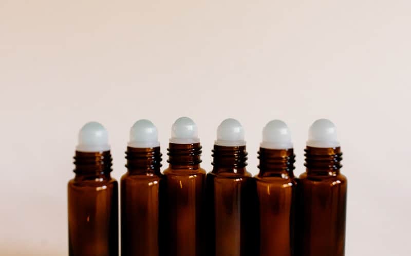 a line of roller balls for essential oils with the tops off