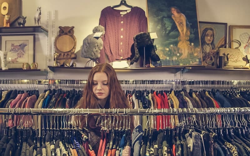 a woman shopping in a thrift store