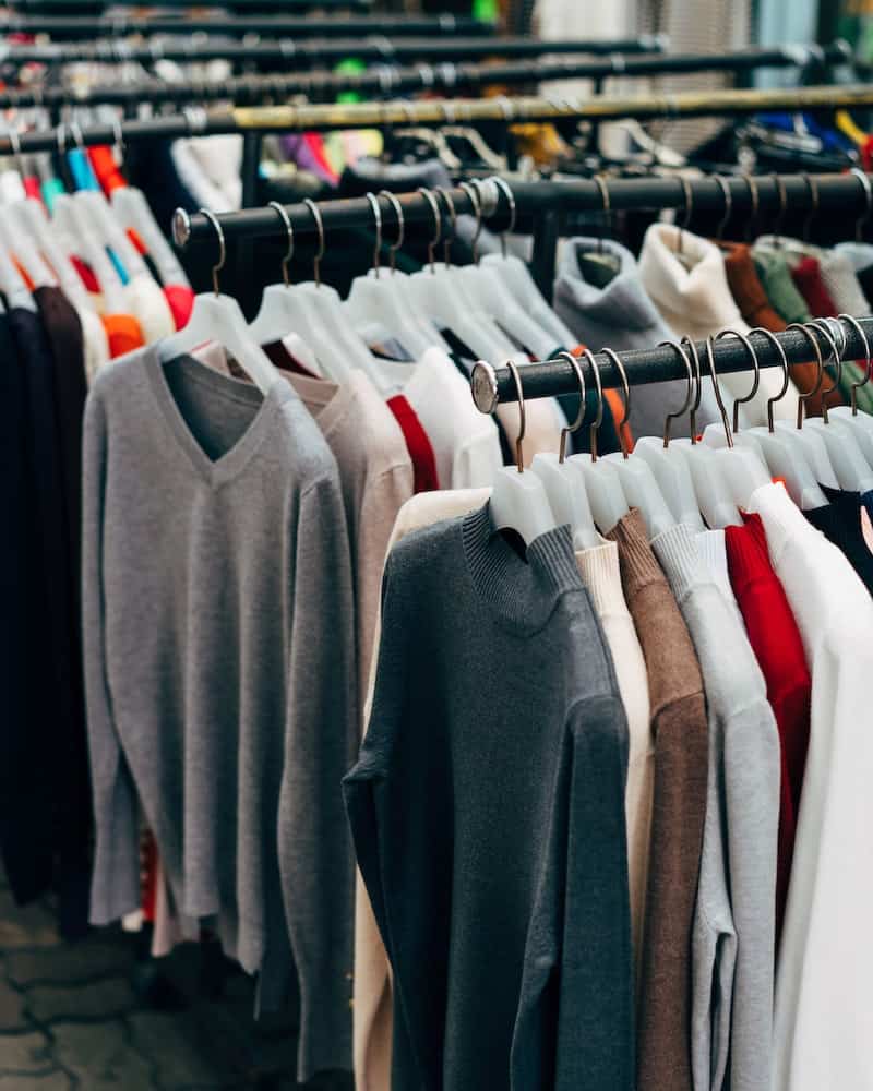 racks of sweaters in a store