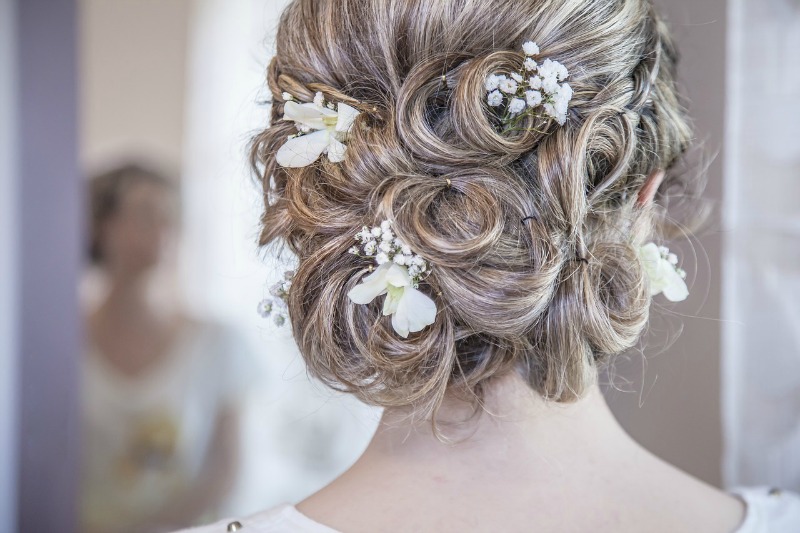 the back of a woman's hair styled for a wedding