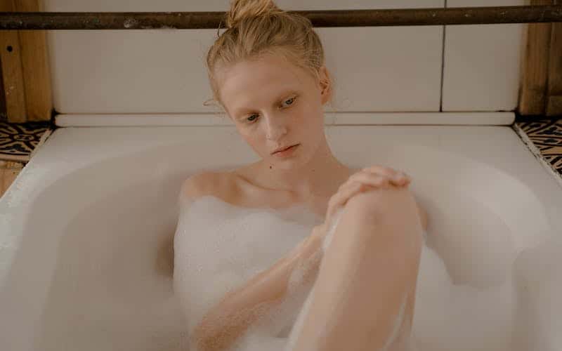 woman sitting in a bubble bath