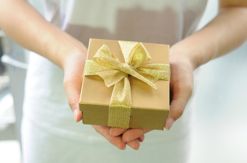 a woman holding a gift box