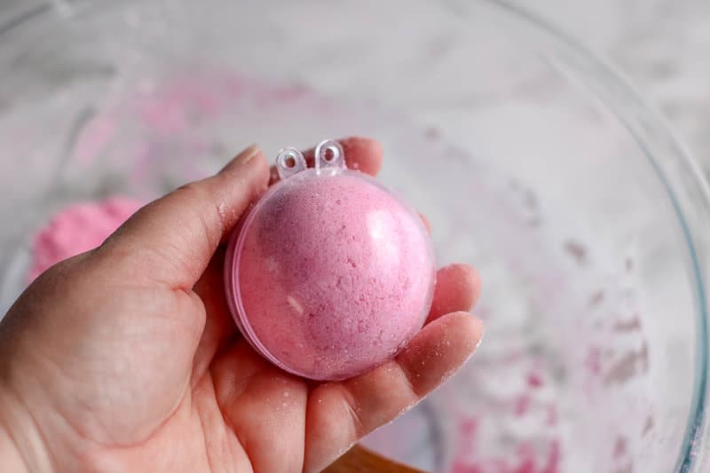 hand holding bath bombs in a mold