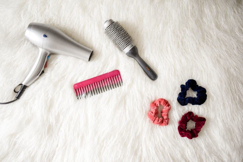 hair styling tools on a white rug