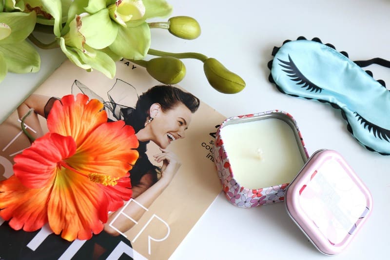 candle, magazine and beauty mask on a white background
