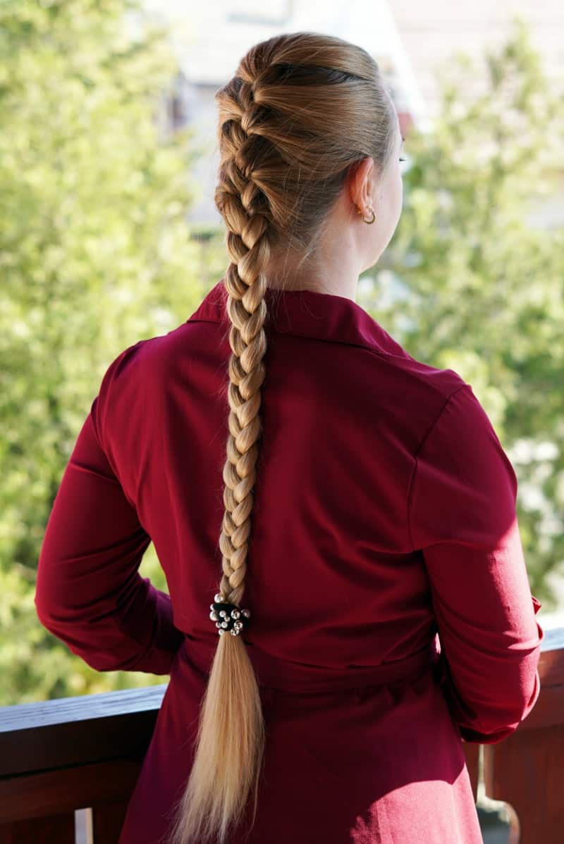 woman wearing a red dress with her hair in a long braid