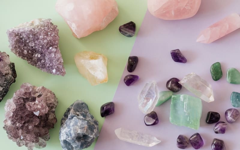 a variety of gemstones on a green and purple background