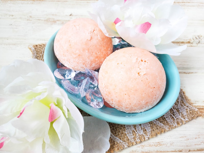two aromatherapy shower steamers in a blue soap dish
