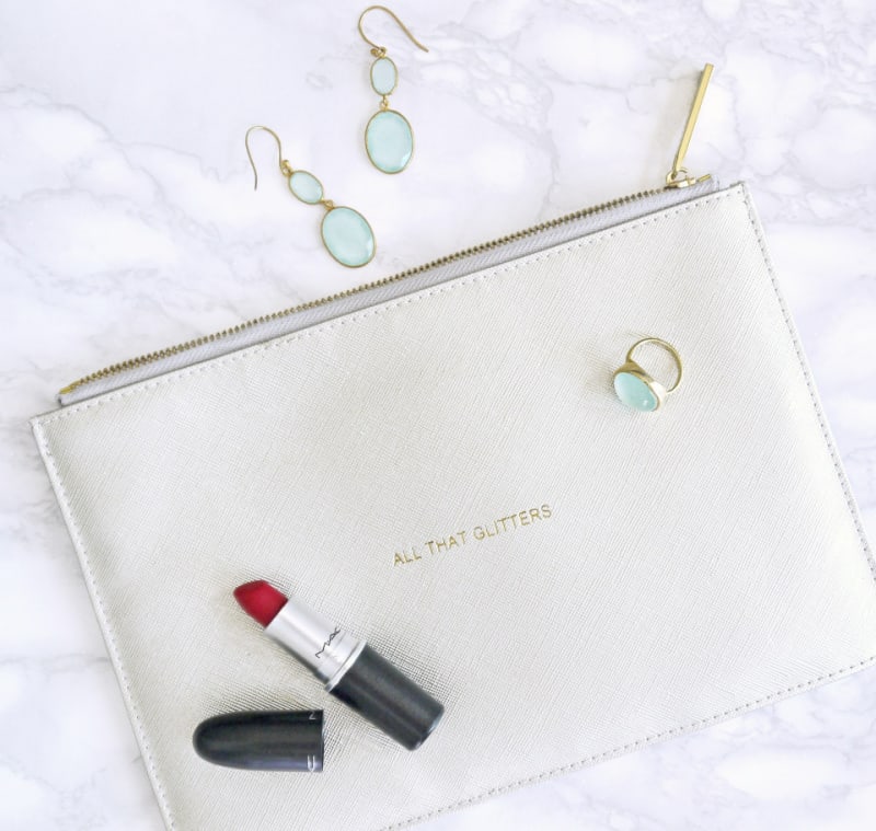 a cosmetic bag with lipstick and jewelry
