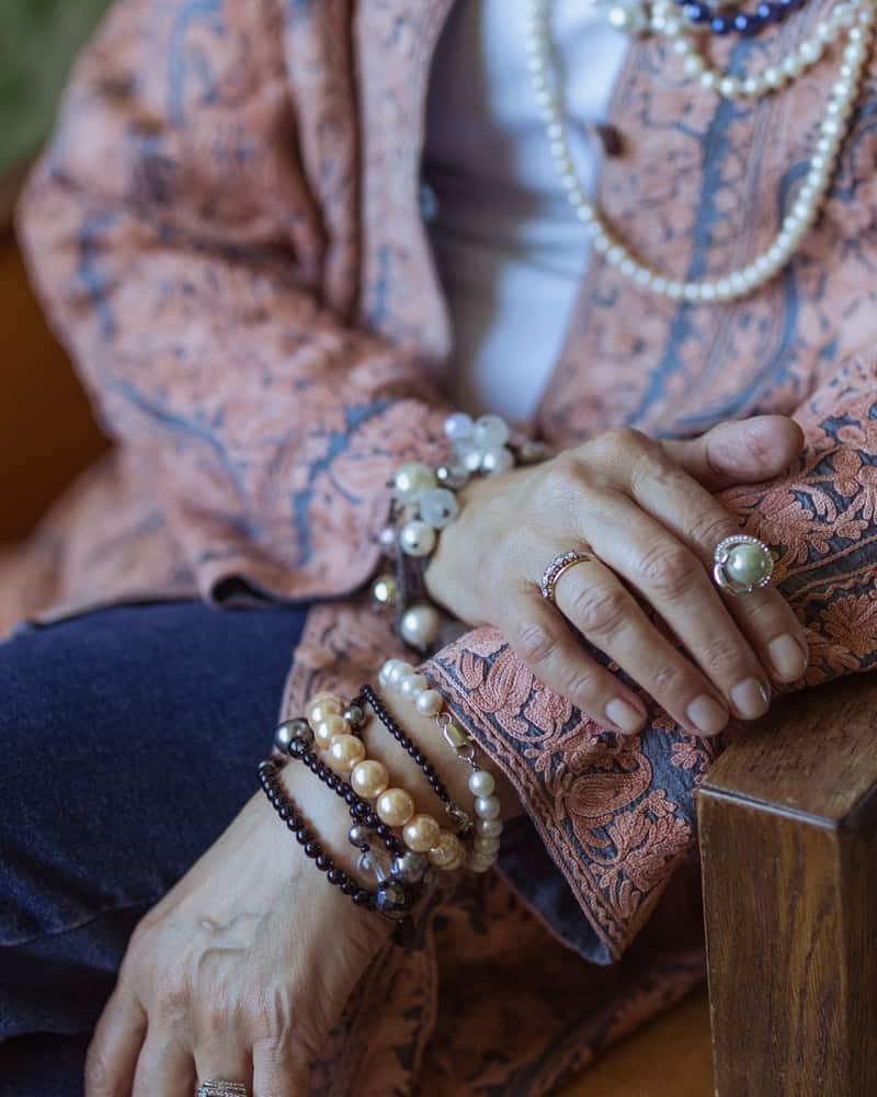 a woman wearing statement jewelry with winter boho style clothes
