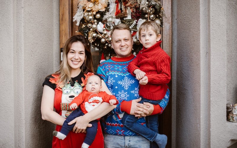 a family wearing ugly Christmas sweaters