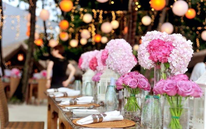 pink flowers on a table at a wedding