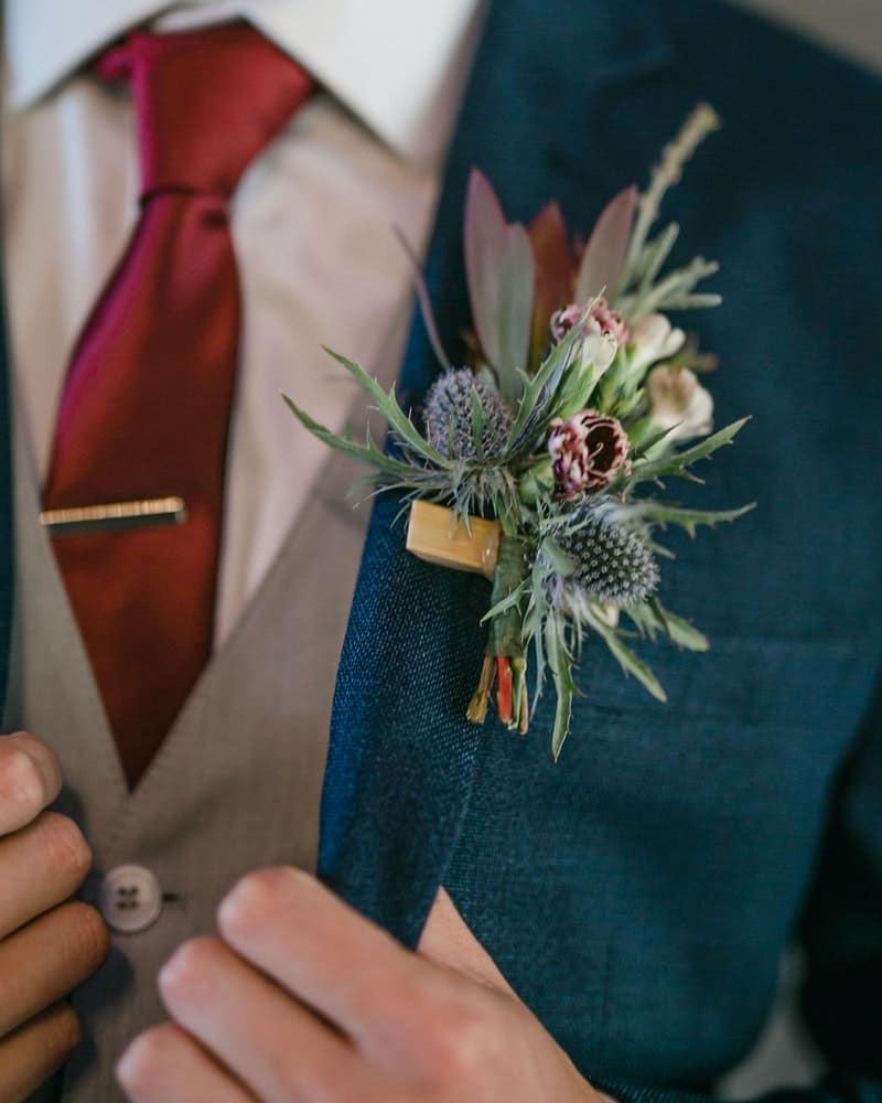 Wondering how to wear a boutonniere? Learn more about how to wear small flowers on your lapel for special occasions.