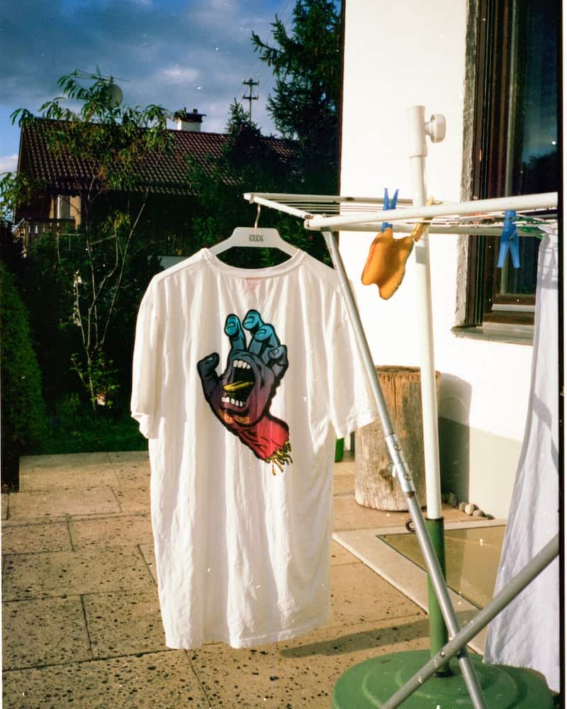 a t shirt hanging on a rack to dry