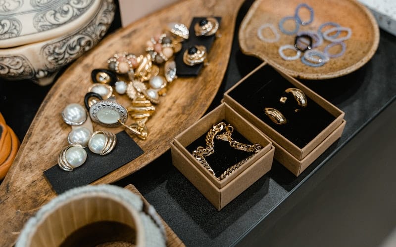 a tray of jewelry and earrings
