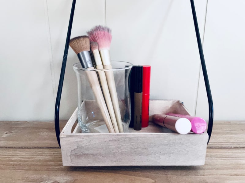 brushes and lipsticks stored in a makeup organizer