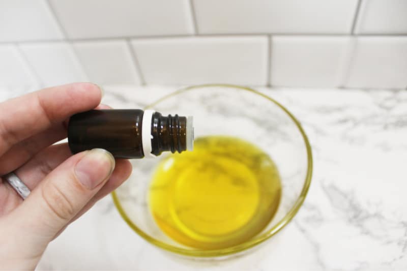 adding essential oil to a bowl