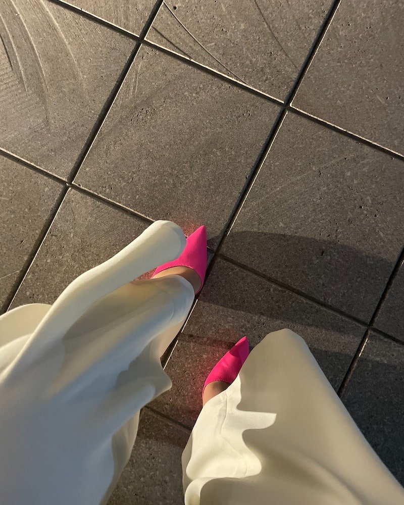 close up shot of wide leg pants a pink heels
