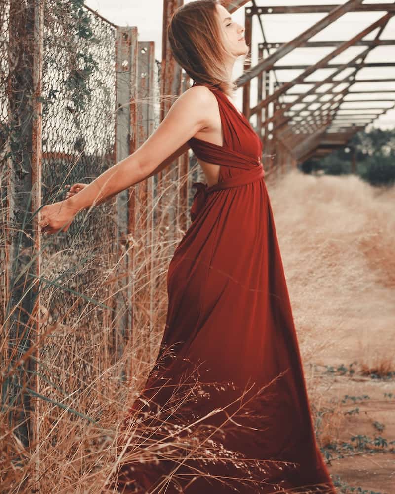 woman wearing a rust dress in the fall
