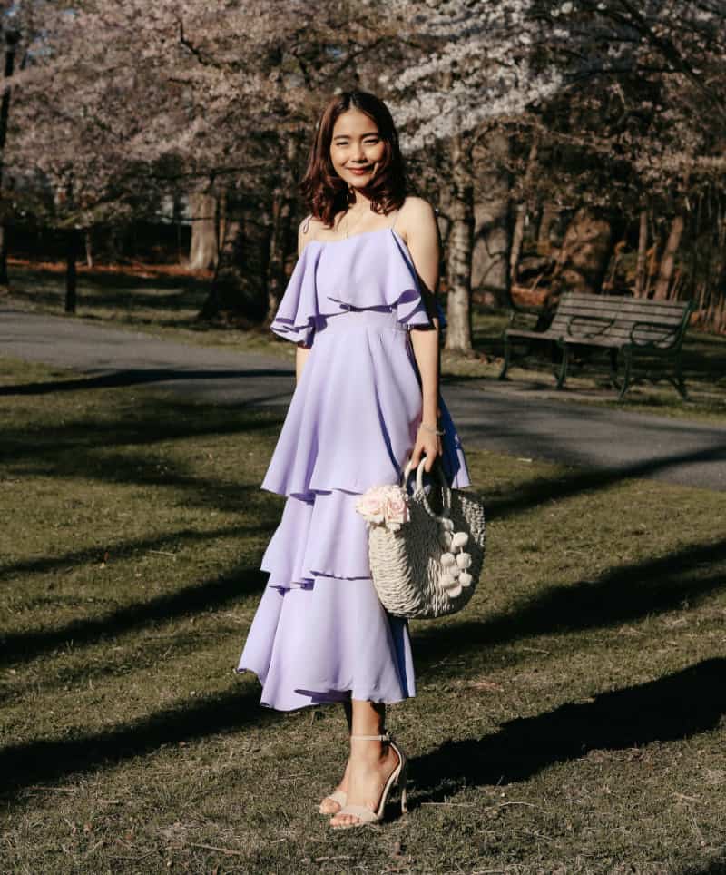 woman wearing a lavender spring wedding guest dress