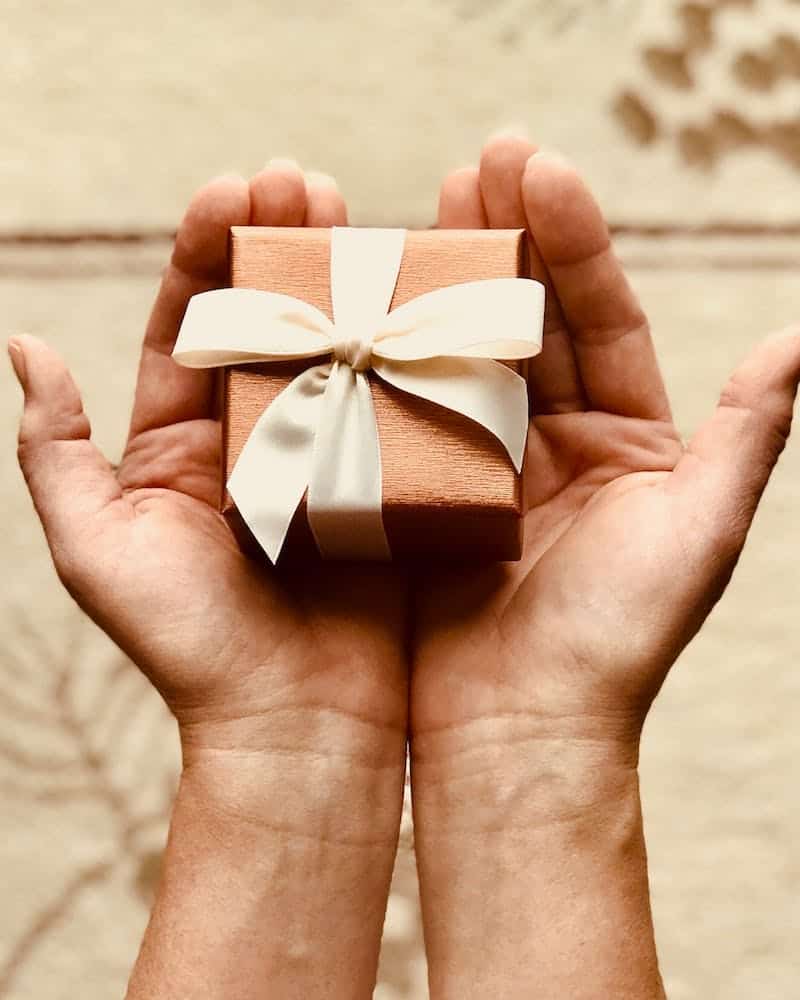 person holding a small gift