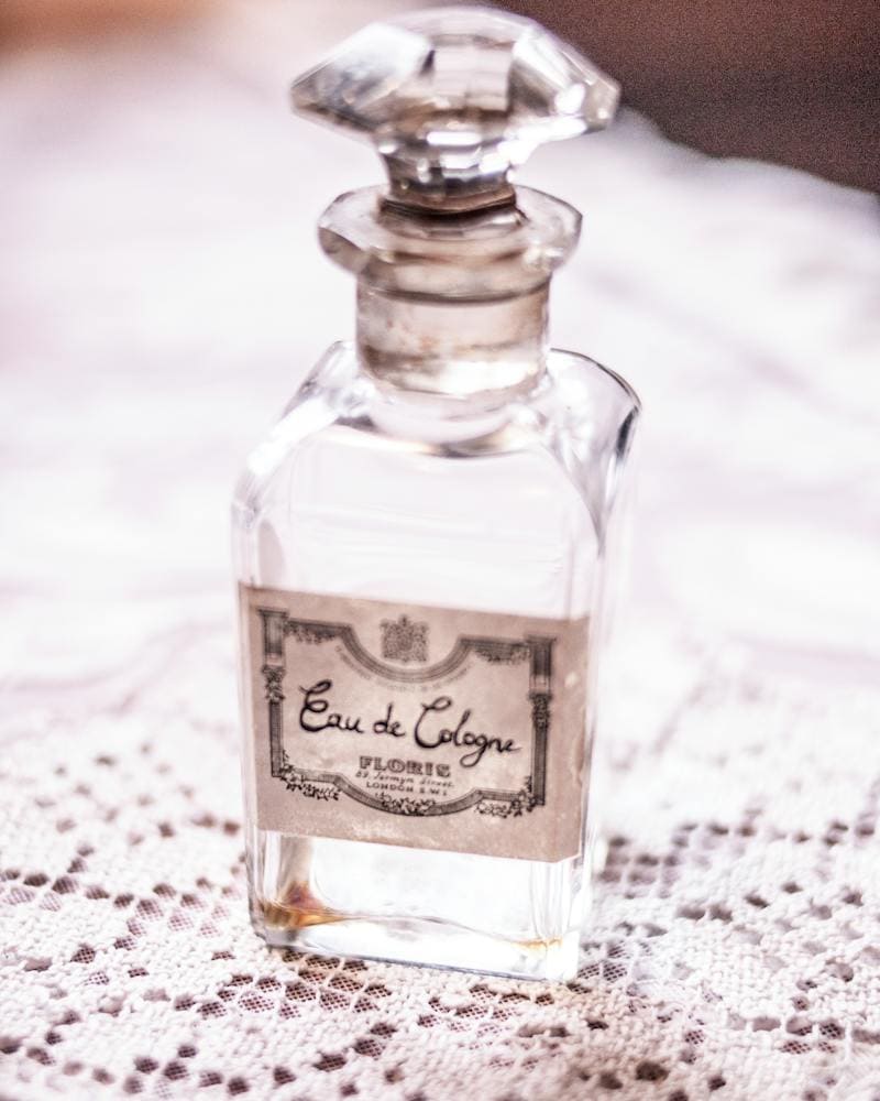 old glass perfume bottle on a lace doily