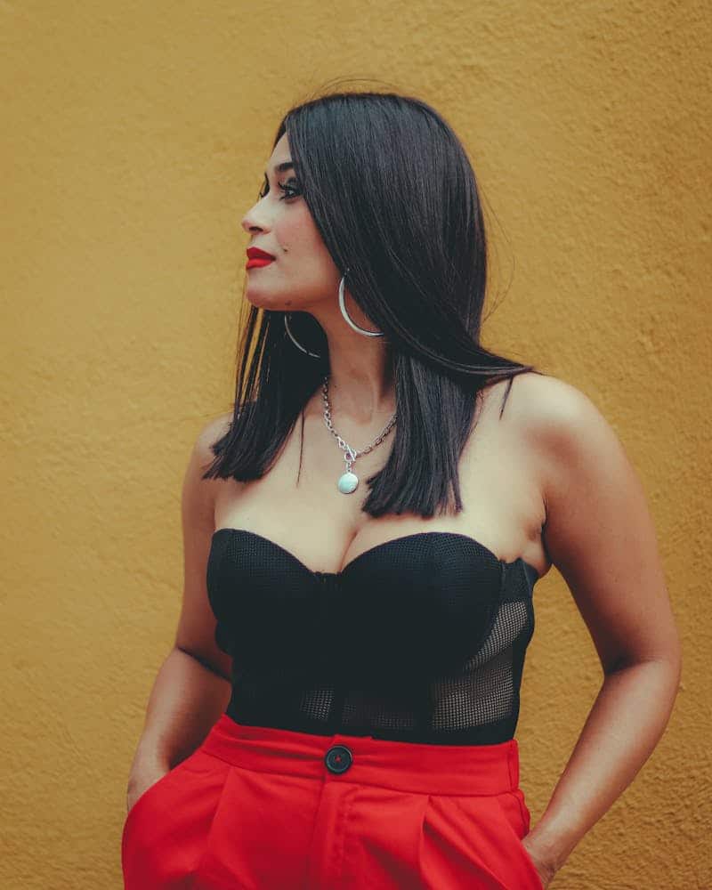 woman wearing red pants and black corset top
