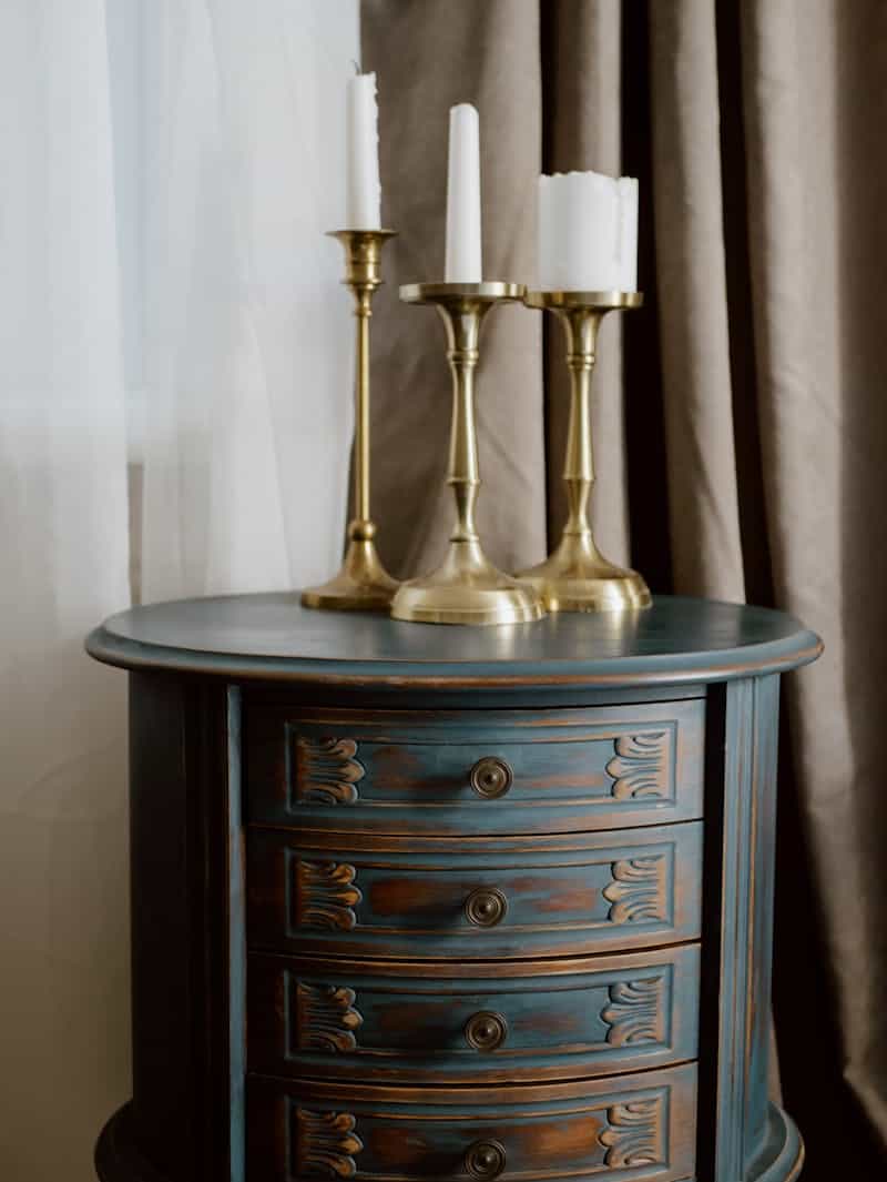 tall dresser with gold candle holders