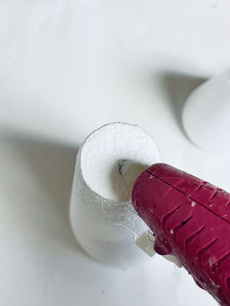 adding hot glue to styrofoam