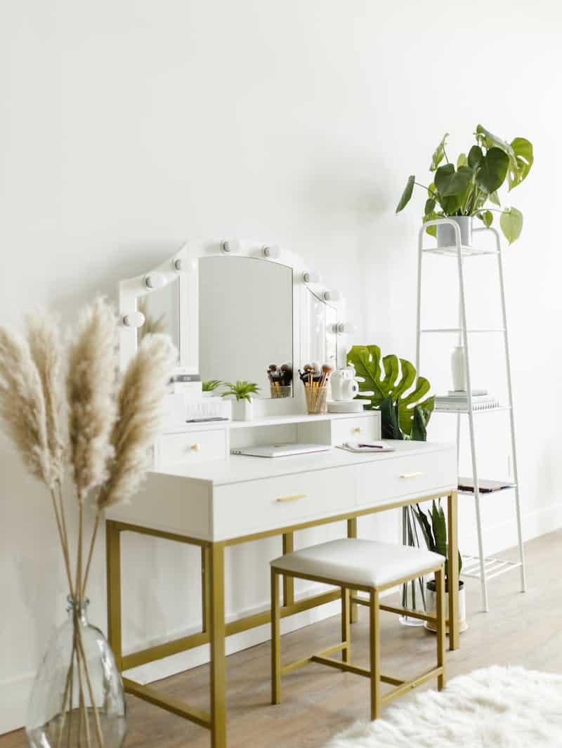 White vanity table with candle holders and decor