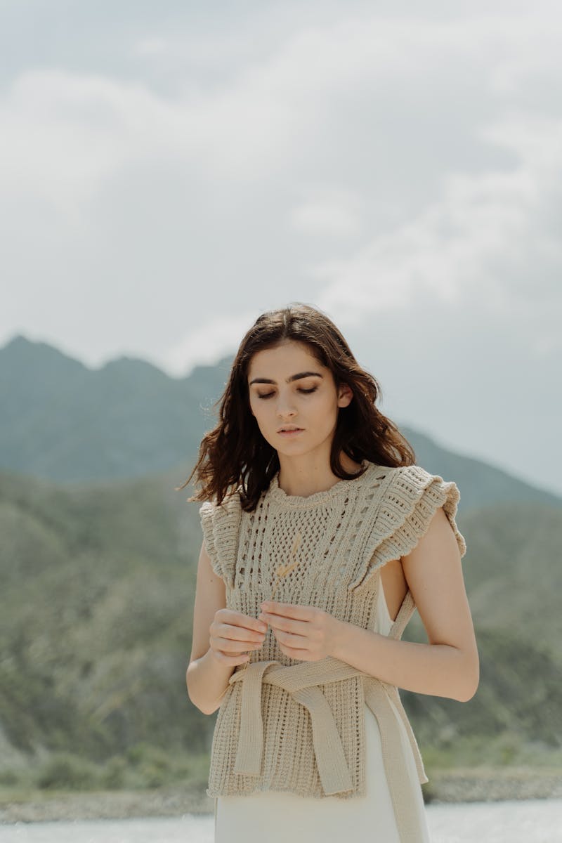 woman tying a sweater with a belt