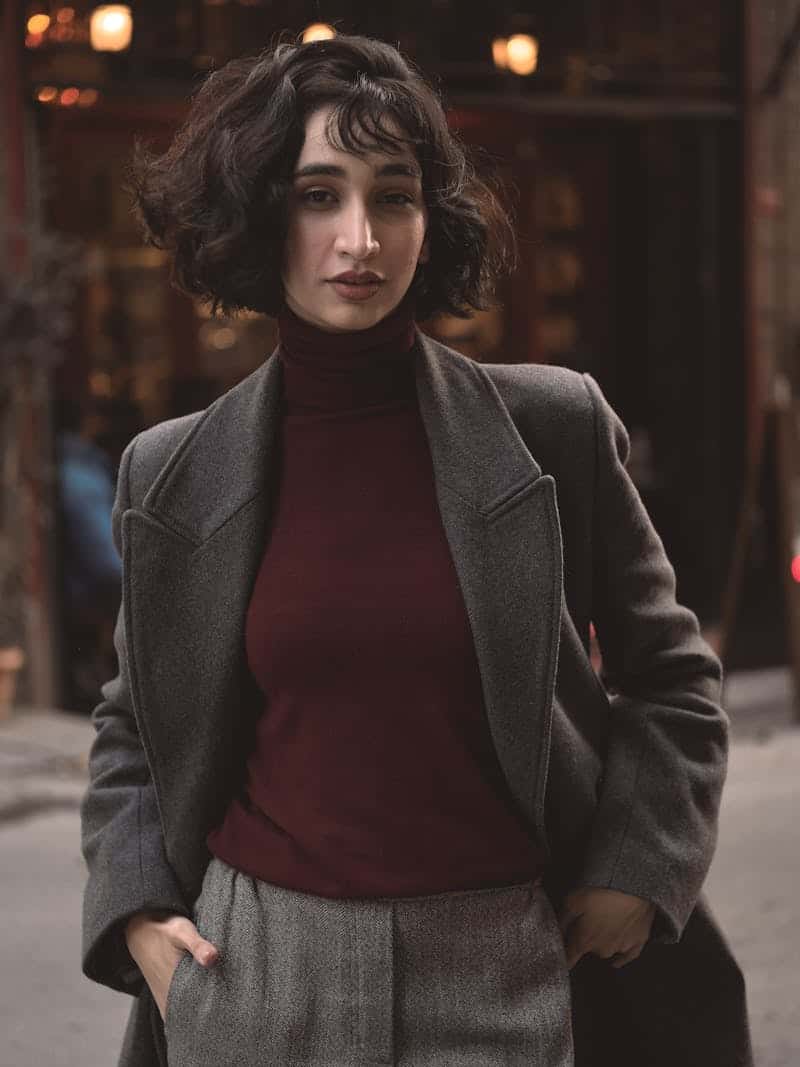 woman wearing a red turtleneck and blazer