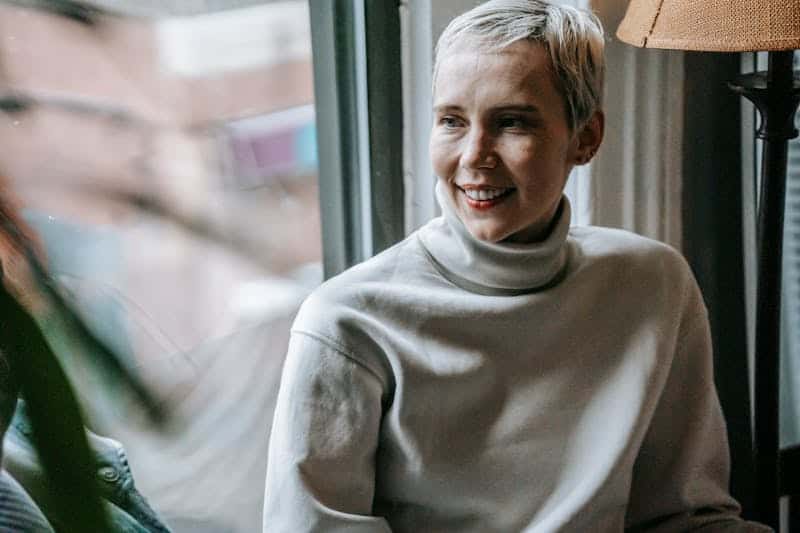 woman smiling wearing a grey shirt