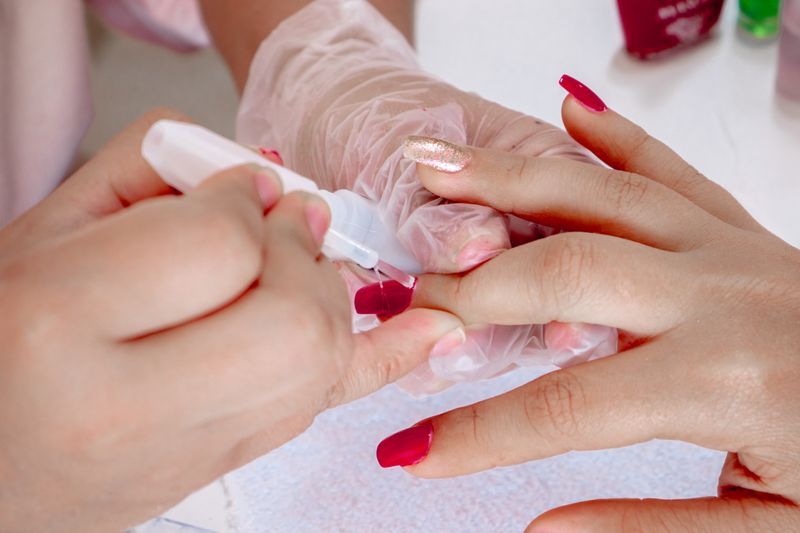 person applying nail polish