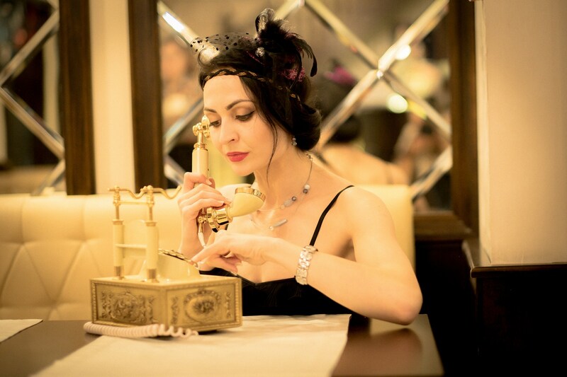 woman on vintage phone looking at jewelry